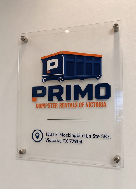 Brushed-steel-mounted acrylic sign showing the Primo logo above the street address